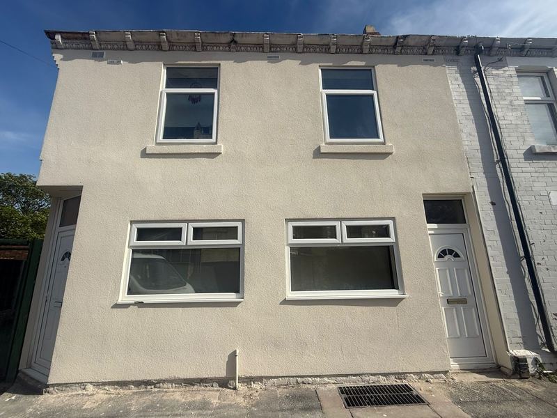 Terraced property finished in render with white trims