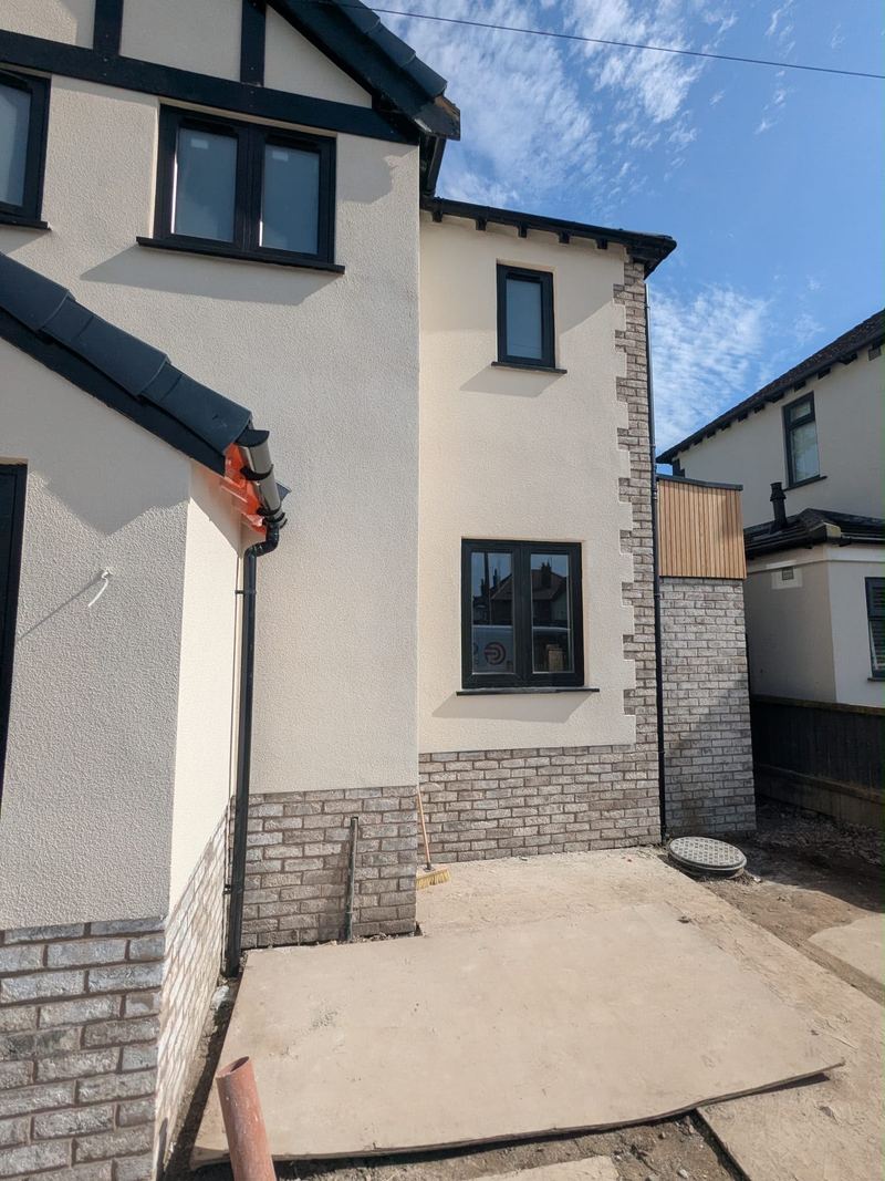 Rendered extension with brick base and cedar cladding